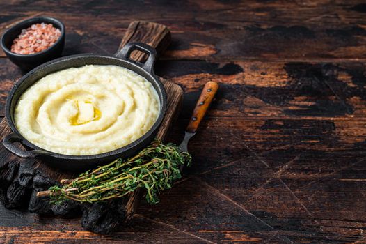 Mashed potatoes in a pan on wooden rustic table. Wooden background. Top view. Copy space.