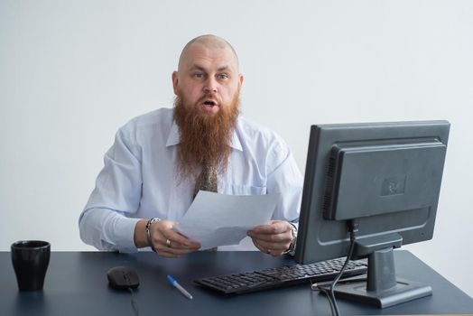 Portrait of a bald man at a desk looking at a report and cursing. The dissatisfied boss dismisses the subordinate