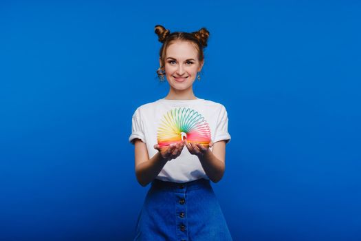 alluring young woman in white t-shirt and blue jeans posing over white background
