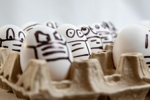 close up of set of Easter eggs with drawn medical masks and emotions. copy space