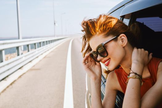 pretty woman in sunglasses rides in a travel car. High quality photo