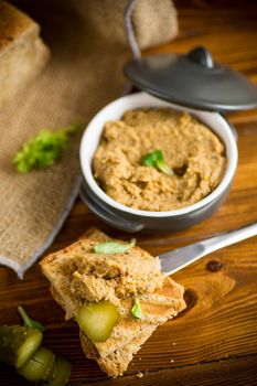 fried buckwheat croutons with cooked homemade pate on a wooden table