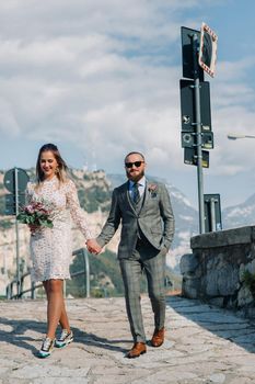 Beautiful elegant family with walks in the mountains on lake Garda in Italy. A couple walks through the mountainous part of Italy