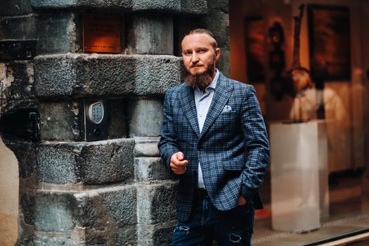Bearded man in a suit in the old city of Lyon, stylish man in a suit in France.
