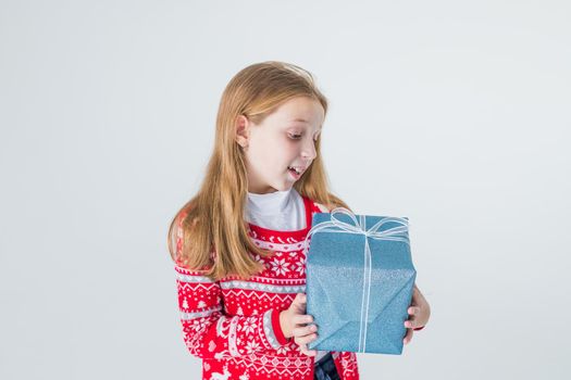 happy little girl open box with christmas present, isolated on white background