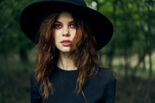 woman dressed as a witch in the forest Halloween fantasy ritual. High quality photo