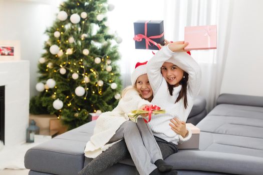 Christmas Happy funny children twins sisters at home