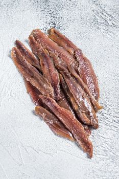 Canned Anchovies fish fillet in Olive Oil. White background. Top view.