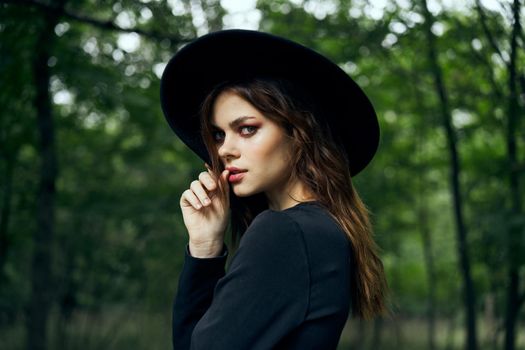 woman dressed as a witch in the forest Halloween fantasy ritual. High quality photo