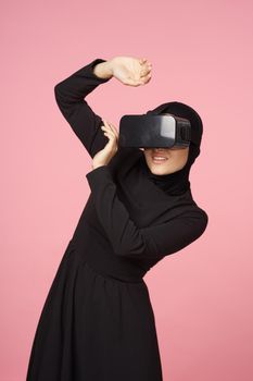 woman in black hijab glasses virtual reality technology movie watching. High quality photo