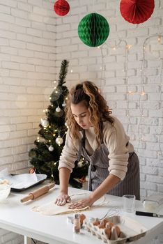 Merry christmas and happy new year. Smiling woman in the kitchen baking christmas cookies