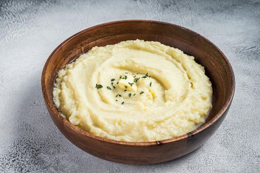 Boiled potato puree, Mashed potatoes in a wooden plate. White background. Top view.