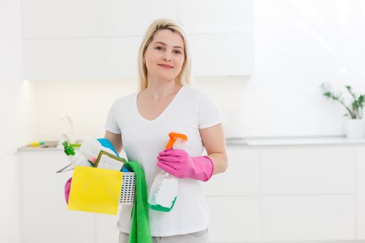 Portrait of smiling young housewife in modern kitchen