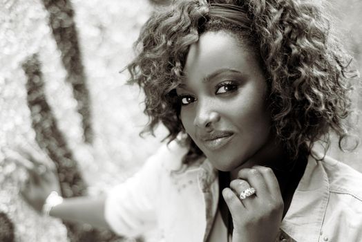 Portrait of beautiful black woman in urban background with red hair