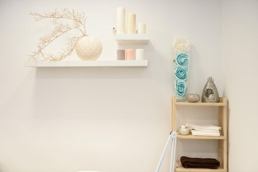 Decoration details in modern wellness center with flower vase and candles. Beauty and Aesthetic concepts.