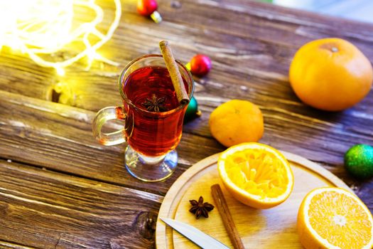 One glass mulled white wine on a rustic wooden table.