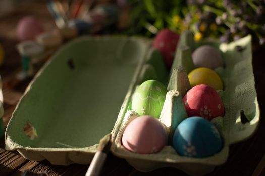 Table with paint and brush for painting easter eggs.