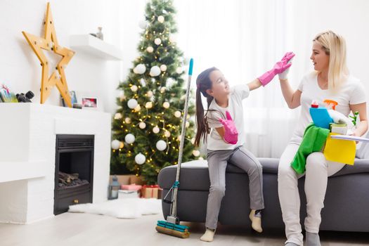 daughter and mother cleaning the apartment before christmas