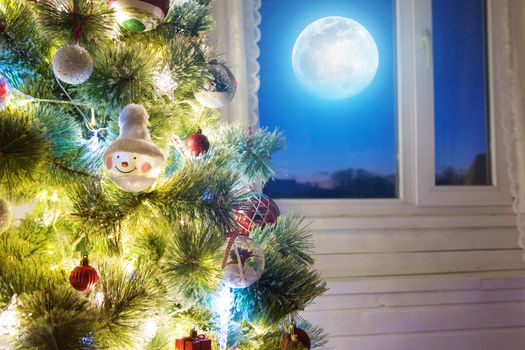 Christmas home room with tree and moon lighting in window. The elements of this image furnished by NASA.