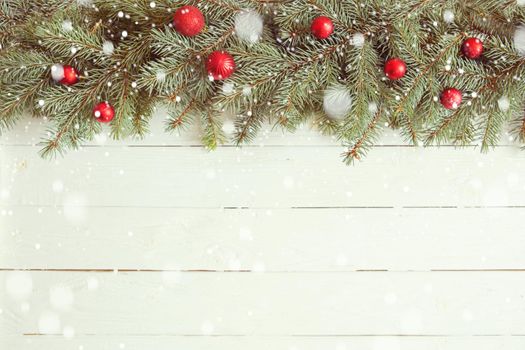 Red Christmas decoration on white wooden background.