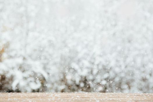 wooden old table with frost and forest on background. Atmosphere of magic and fairy tales .