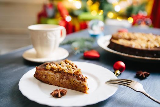 Christmas fruit cake on a gray background Gluten free christmas nut cake on a gray table with christmas decorations .