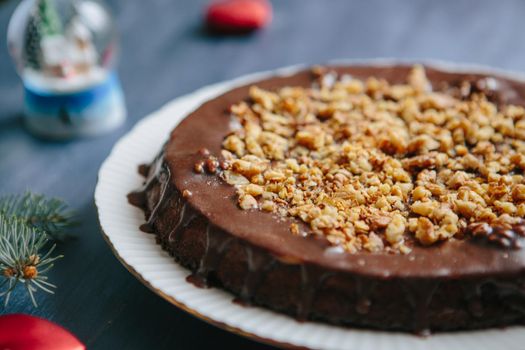 Traditional homemade cake with dried fruits and nuts Gluten free christmas nut cake on a gray table with christmas decorations .