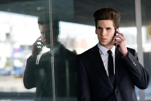 Portrait of an attractive young businessman on the phone in an office building