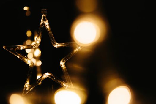 Christmas lights on dark background. Star shaped. .
