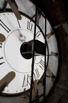 Clock face of old wall clock - mechanism inside, vertical, close up