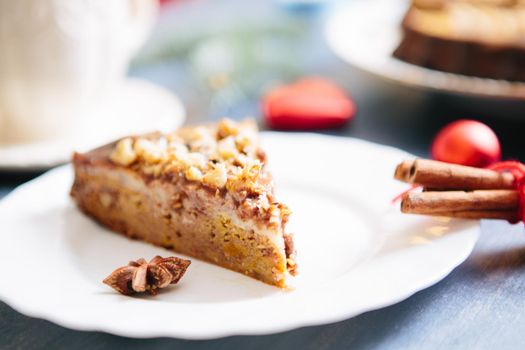 Nuts and honey cake, selective focus Gluten free christmas nut cake on a gray table with christmas decorations .