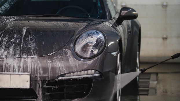 Washing a luxury car in the suds - telephoto, close up