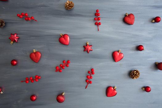 Gray wooden christmas background with red color christmas decorations. View from above .