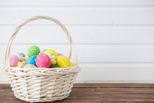 Easter eggs in nest on rustic wooden planks. .