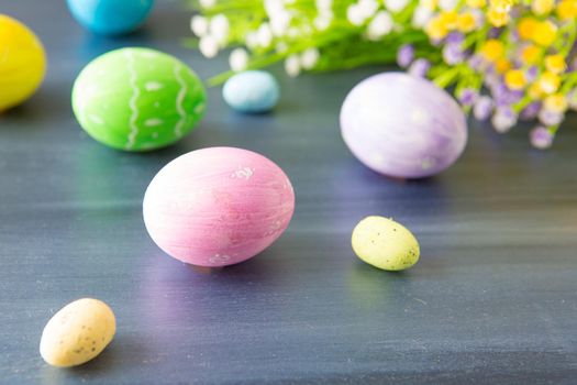 Easter eggs decoration with and flowers on a gray wooden table. .