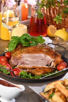 Sliced baked turkey drumstick on a vegetable tray at the Thanksgiving dinner table