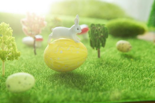 Easter rabbits on a green grass with Easter eggs in Dreamland or fairy world. .