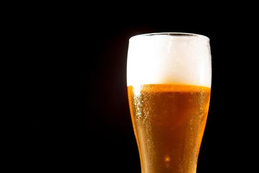 Glass beer on a black background with copyspace