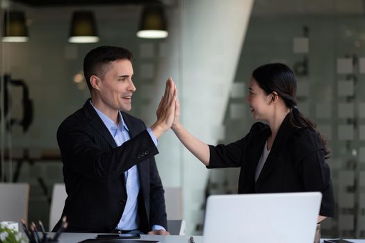 Business man and woman business hi five bump hand together for team work, diversity business team concept