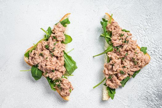 Toast with Canned Tuna fish and arugula. White background. Top view.
