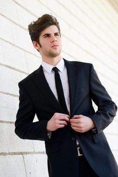 Portrait of an attractive young businessman in urban background