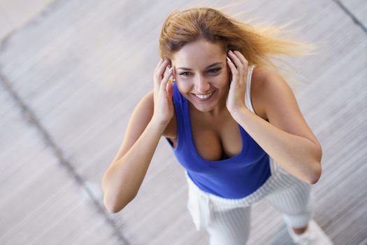 Top view of young girl moving her hair wild outdoors