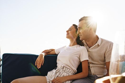 Happy couple in love on a yacht in summer on romantic vacation