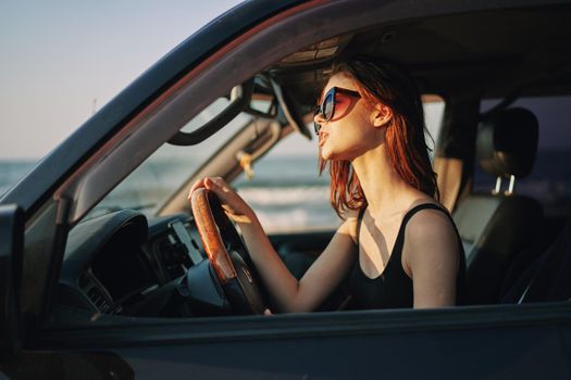 pretty woman in sunglasses driving a car trip. High quality photo