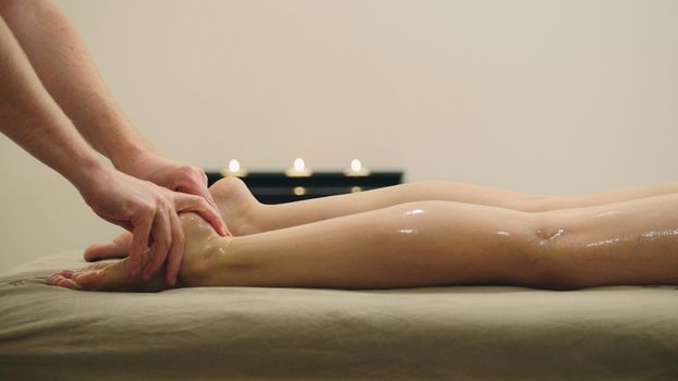 Oil massage for footsteps. Relaxation treatment for young woman, close up, close up view