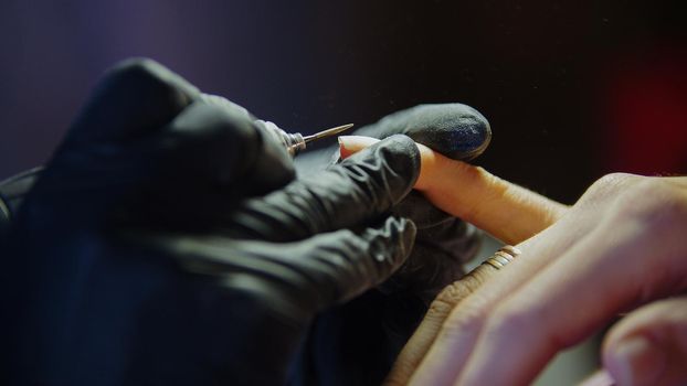 Close up view of professional manicure - nail master in beauty shop, horizontal