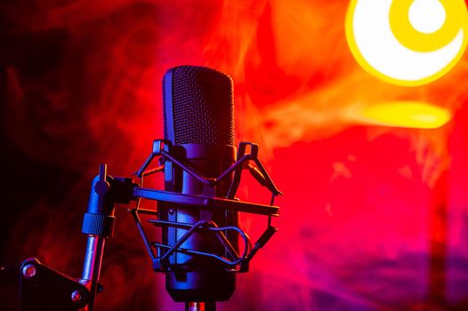 Professional microphone in red smoke on a black background