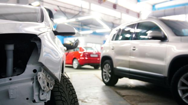 Different cars standing in garage - automobile service, wide angle