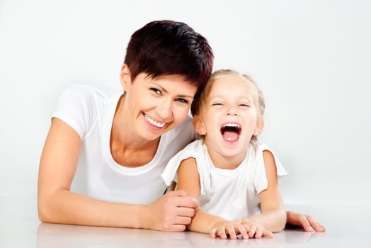 Mother and daughter laughing and looking at camera