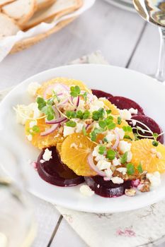 Orange salad with baked beetroot, goat cheese, microgreens and nuts. Perfect as a side dish or as a light lunch for a brunch or dinner.